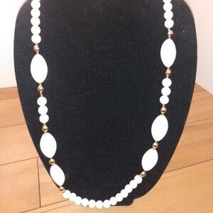 White and gold tone beaded necklace.